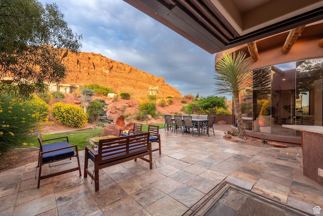 2336 W Entrada Trl Unit 44, St George, UT 84770 - view of patio with outdoor dining area, a mountain view, and outdoor lounge area