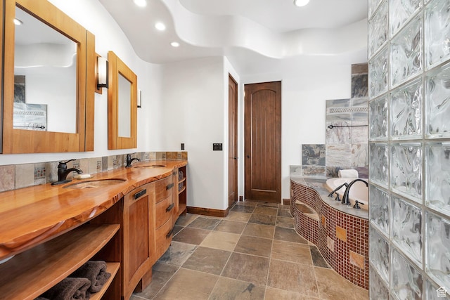 2336 W Entrada Trl Unit 44, St George, UT 84770 - full bath featuring baseboards, recessed lighting, stone finish floors, a garden tub, and vanity