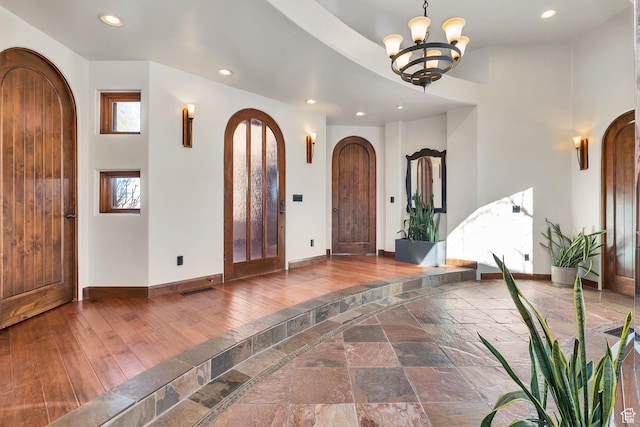 2336 W Entrada Trl Unit 44, St George, UT 84770 - foyer with arched walkways, baseboards, recessed lighting, a chandelier, and wood finished floors