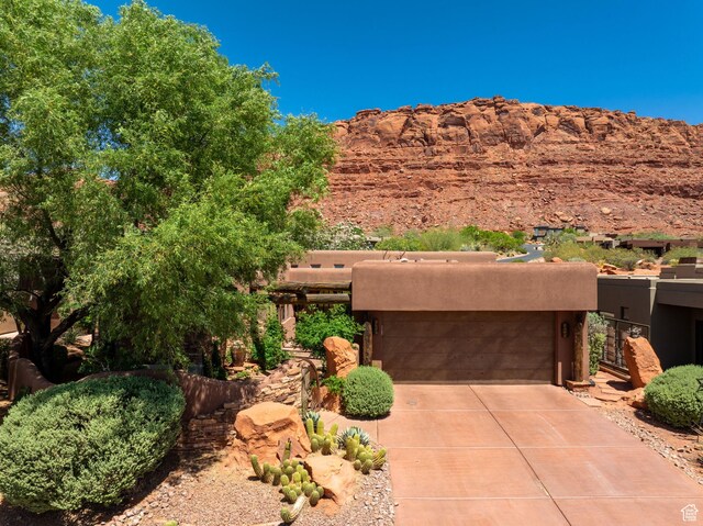 2336 W Entrada Trl Unit 44, St George, UT 84770 - view of front of house featuring driveway, a garage, and stucco siding