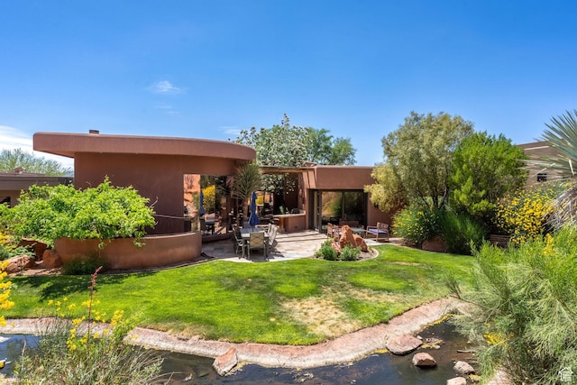 2336 W Entrada Trl Unit 44, St George, UT 84770 - rear view of property with a patio area, a lawn, and stucco siding