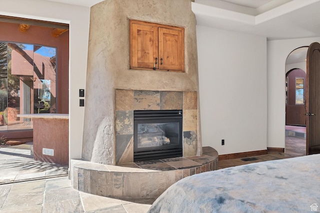 2336 W Entrada Trl Unit 44, St George, UT 84770 - bedroom with a fireplace, baseboards, and arched walkways