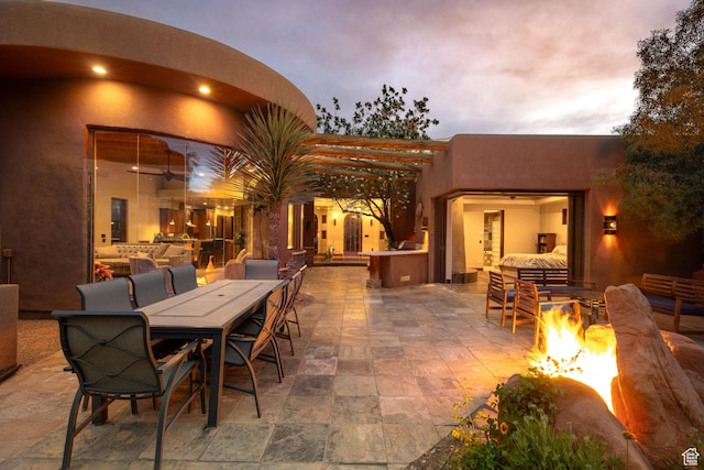 2336 W Entrada Trl Unit 44, St George, UT 84770 - view of patio / terrace featuring a fire pit and outdoor dining area