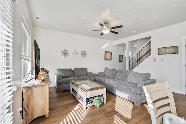 292 N 100 W, Morgan, UT 84050 - living room featuring visible vents, stairs, wood finished floors, a textured ceiling, and a ceiling fan