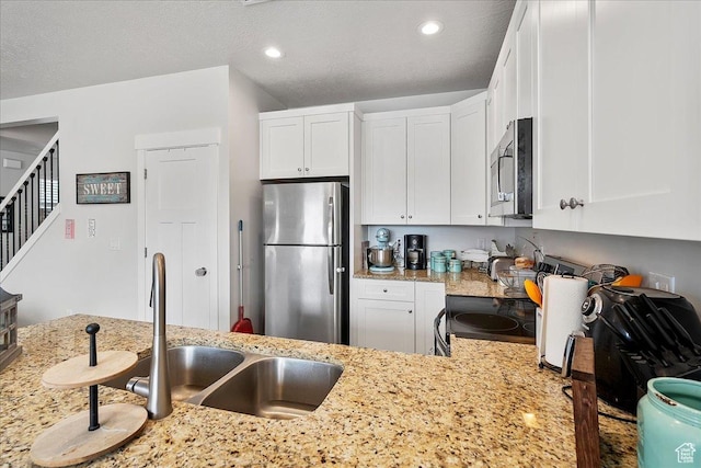 292 N 100 W, Morgan, UT 84050 - kitchen with a sink, light stone counters, appliances with stainless steel finishes, and white cabinetry