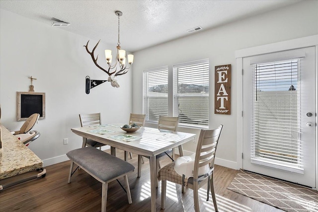 292 N 100 W, Morgan, UT 84050 - dining room featuring visible vents, a textured ceiling, wood finished floors, baseboards, and a chandelier