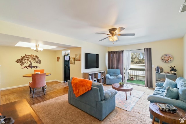5809 S Waterbury Dr Unit D, Murray, UT 84121 - living room featuring visible vents, a ceiling fan, and baseboards