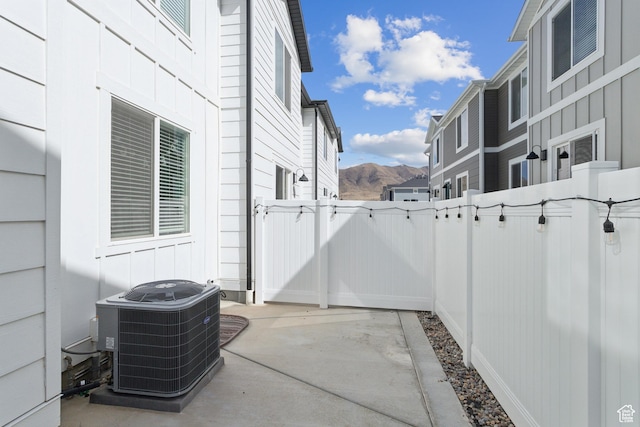 1722 E Muss Dr, Eagle Mountain, UT 84005 - view of patio / terrace featuring central AC unit, a mountain view, fence, and a gate