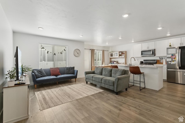 1722 E Muss Dr, Eagle Mountain, UT 84005 - living room with recessed lighting, baseboards, and wood finished floors
