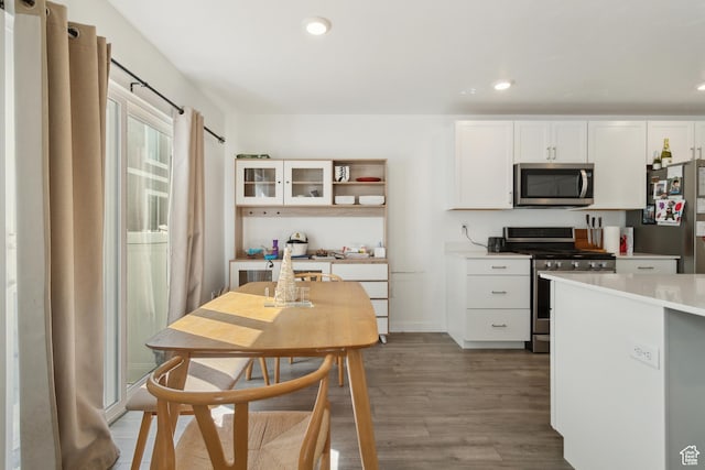 1722 E Muss Dr, Eagle Mountain, UT 84005 - kitchen featuring stainless steel appliances, wood finished floors, white cabinets, and light countertops