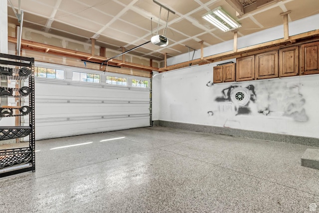 garage featuring baseboards and a garage door opener