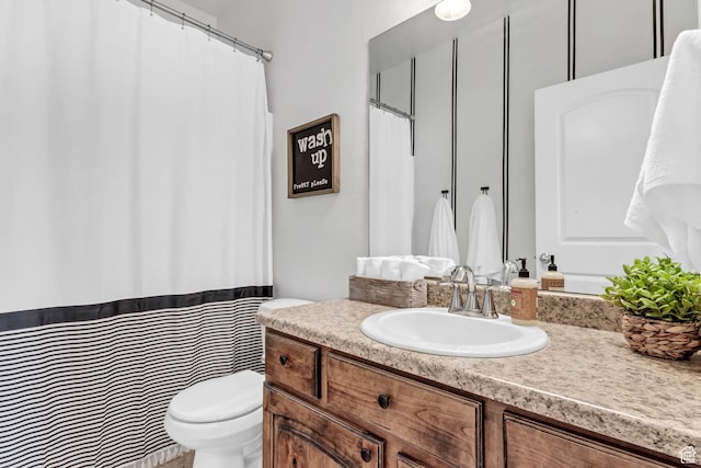 bathroom featuring toilet and vanity