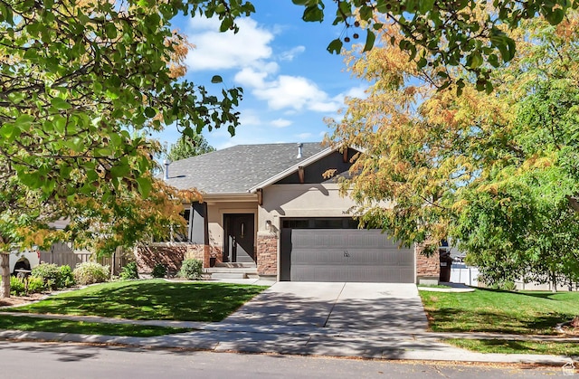 view of front of home with stucco siding, an attached garage, driveway, and a shingled roof