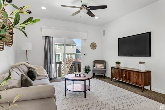 carpeted living room featuring a ceiling fan, baseboards, and recessed lighting