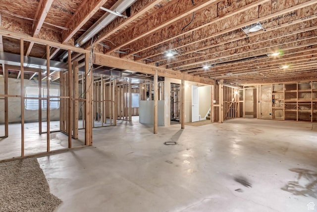 unfinished basement featuring stairs