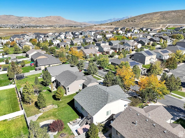 aerial view of property and surrounding area featuring nearby suburban area and mountains