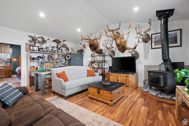 2386 N 3900 W, Corinne, UT 84307 - living area featuring a wood stove, lofted ceiling, and wood finished floors