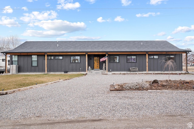 2386 N 3900 W, Corinne, UT 84307 - view of front of property featuring a front lawn, driveway, board and batten siding, and roof with shingles