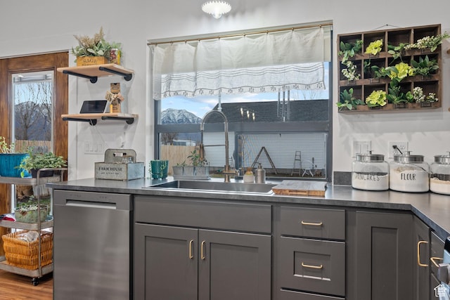 2386 N 3900 W, Corinne, UT 84307 - kitchen featuring gray cabinets, open shelves, a sink, stainless steel dishwasher, and dark countertops