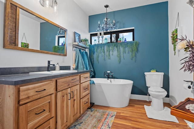 2386 N 3900 W, Corinne, UT 84307 - full bathroom featuring vanity, wood finished floors, a soaking tub, an inviting chandelier, and toilet