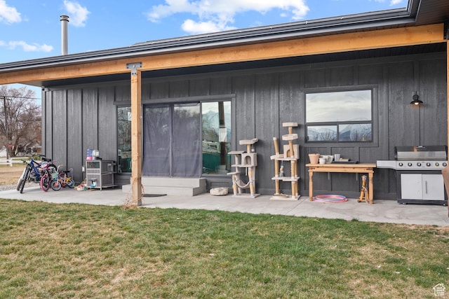 2386 N 3900 W, Corinne, UT 84307 - rear view of house featuring a yard, a patio area, and board and batten siding