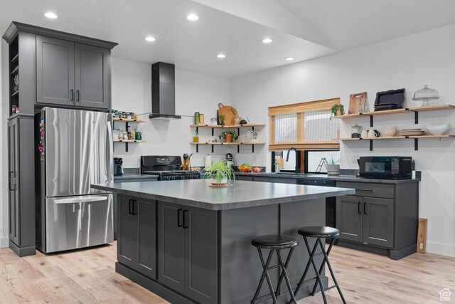 2386 N 3900 W, Corinne, UT 84307 - kitchen featuring dark countertops, a center island, black appliances, wall chimney exhaust hood, and open shelves