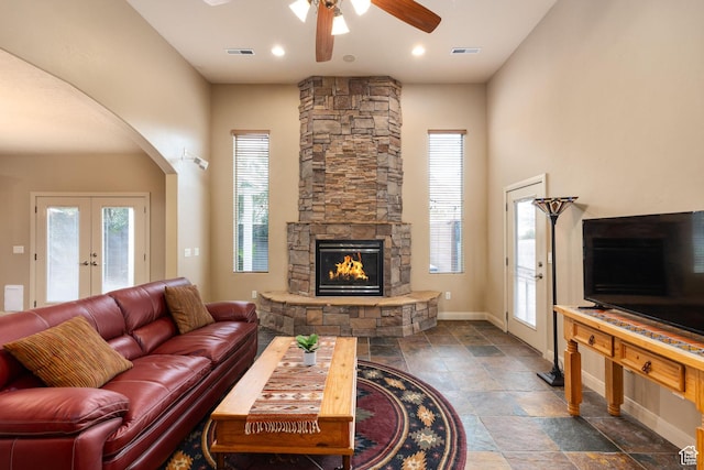 1815 N Red Mountain Dr, Santa Clara, UT 84765 - living room with visible vents, arched walkways, a fireplace, baseboards, and ceiling fan