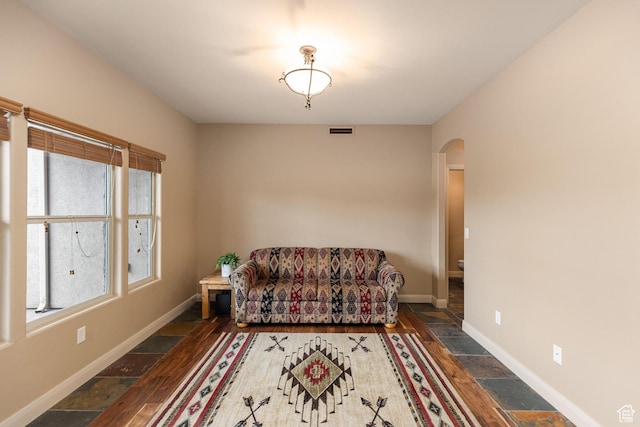1815 N Red Mountain Dr, Santa Clara, UT 84765 - sitting room with arched walkways, visible vents, stone tile floors, and baseboards