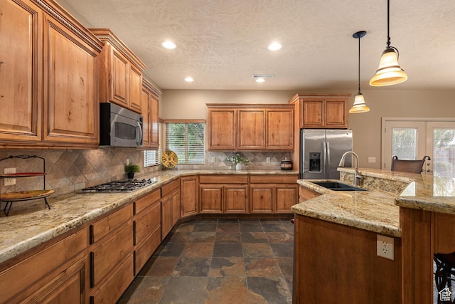 1815 N Red Mountain Dr, Santa Clara, UT 84765 - kitchen featuring a sink, stone finish flooring, tasteful backsplash, stainless steel appliances, and brown cabinetry