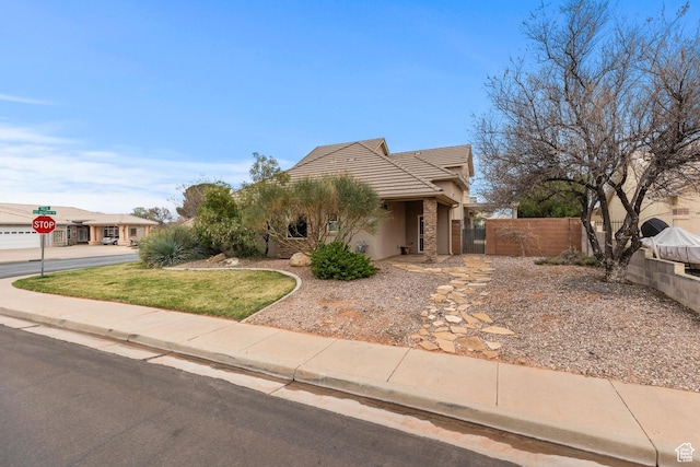 1815 N Red Mountain Dr, Santa Clara, UT 84765 - view of front of home featuring a gate, stucco siding, fence, and a tiled roof