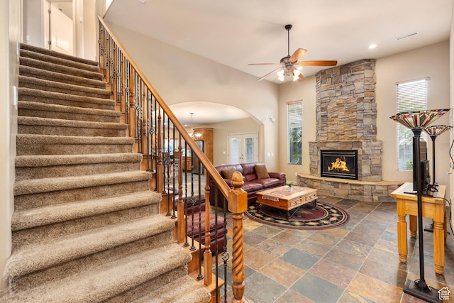 1815 N Red Mountain Dr, Santa Clara, UT 84765 - living room with arched walkways, a fireplace, stairs, and ceiling fan