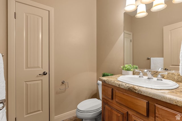 1815 N Red Mountain Dr, Santa Clara, UT 84765 - bathroom with baseboards, toilet, and vanity