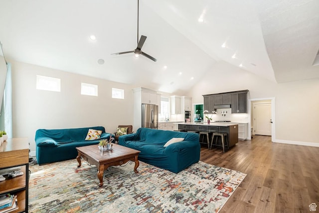 1959 E Deer Crest Cir N, Logan, UT 84341 - living area with light wood-style flooring, a ceiling fan, baseboards, and high vaulted ceiling