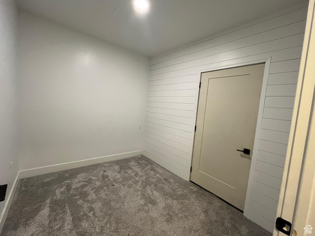 1959 E Deer Crest Cir N, Logan, UT 84341 - empty room with wood walls and carpet floors