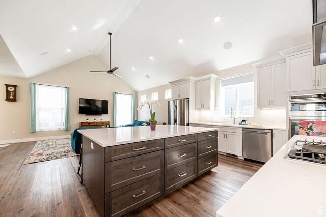 1959 E Deer Crest Cir N, Logan, UT 84341 - kitchen featuring light countertops, white cabinets, appliances with stainless steel finishes, and vaulted ceiling