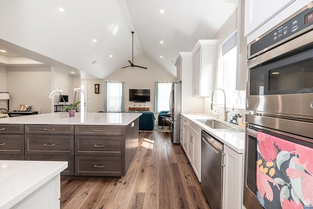 1959 E Deer Crest Cir N, Logan, UT 84341 - kitchen with dark wood-type flooring, open floor plan, light countertops, appliances with stainless steel finishes, and a sink