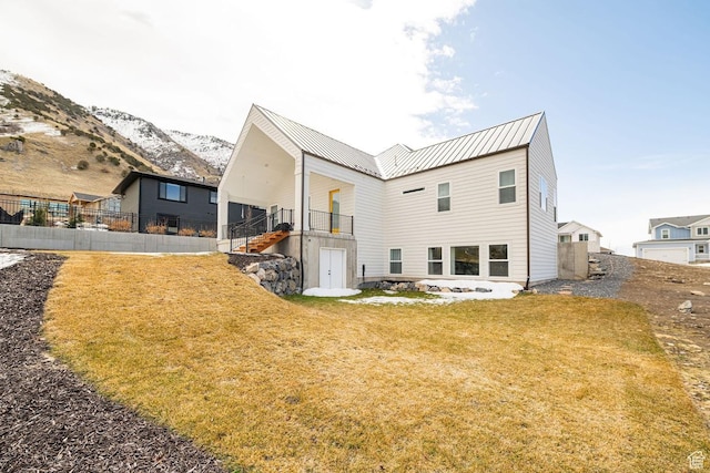 1959 E Deer Crest Cir N, Logan, UT 84341 - back of property with metal roof, a lawn, stairs, and fence