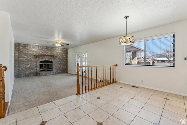3902 W Angus Dr, South Jordan, UT 84009 - unfurnished dining area with ceiling fan, a textured ceiling, a brick fireplace, light carpet, and baseboards