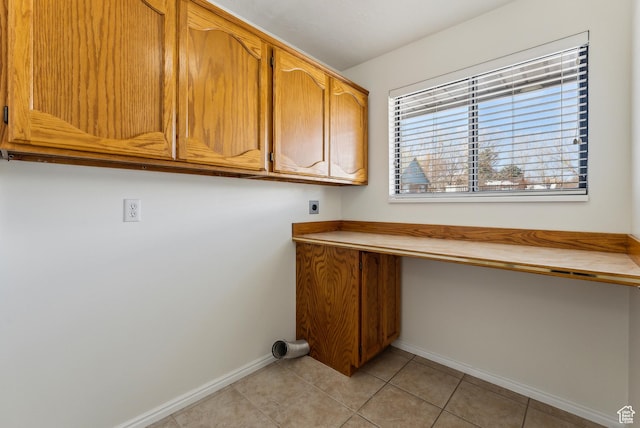 3902 W Angus Dr, South Jordan, UT 84009 - clothes washing area with hookup for an electric dryer, baseboards, cabinet space, light tile patterned floors, and a desk