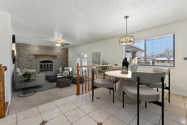 3902 W Angus Dr, South Jordan, UT 84009 - dining room featuring ceiling fan, a textured ceiling, light tile patterned floors, light colored carpet, and a brick fireplace