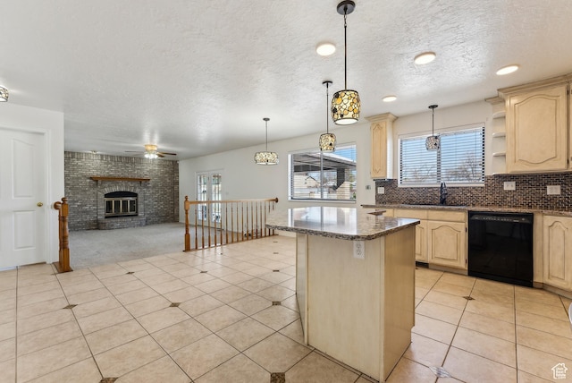 3902 W Angus Dr, South Jordan, UT 84009 - kitchen featuring black dishwasher, light brown cabinetry, a sink, a kitchen island, and a textured ceiling