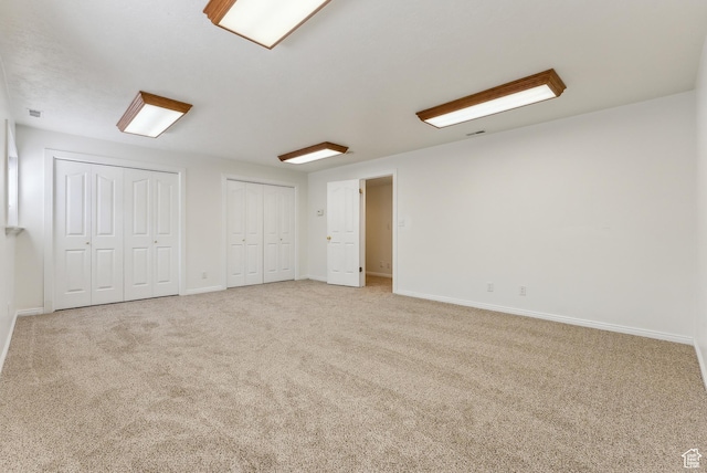 3902 W Angus Dr, South Jordan, UT 84009 - unfurnished bedroom featuring two closets, carpet floors, and baseboards