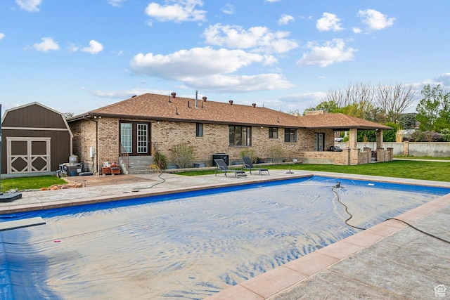 3902 W Angus Dr, South Jordan, UT 84009 - view of pool with a patio area, a shed, a lawn, entry steps, and an outbuilding