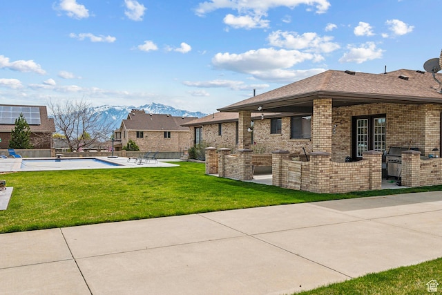 3902 W Angus Dr, South Jordan, UT 84009 - view of yard with exterior kitchen, a patio, and a mountain view