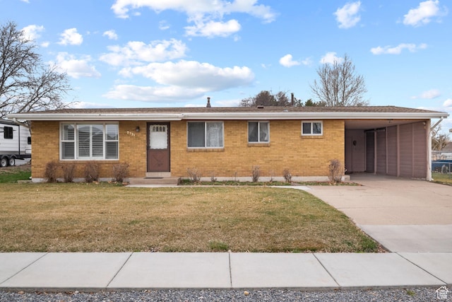 ranch-style home with brick siding, driveway, a carport, and a front yard