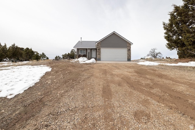 46501 W Bandanna Dr, Fruitland, UT 84027 - view of front of property featuring a garage, metal roof, and driveway