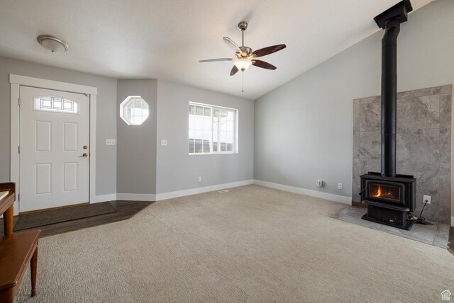46501 W Bandanna Dr, Fruitland, UT 84027 - unfurnished living room featuring carpet flooring, lofted ceiling, ceiling fan, and a wood stove