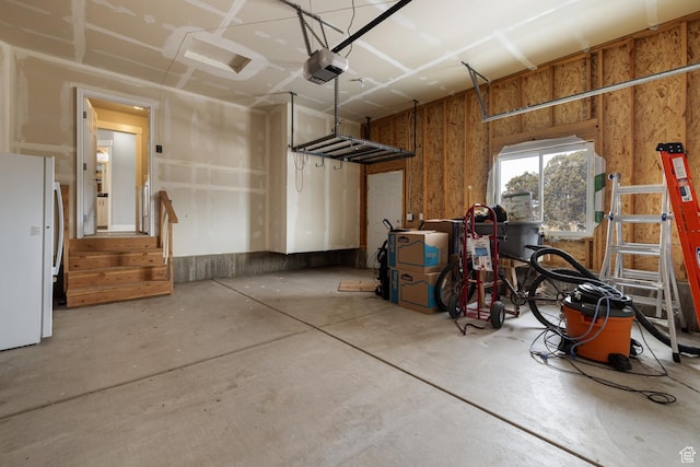 46501 W Bandanna Dr, Fruitland, UT 84027 - garage featuring a garage door opener and freestanding refrigerator