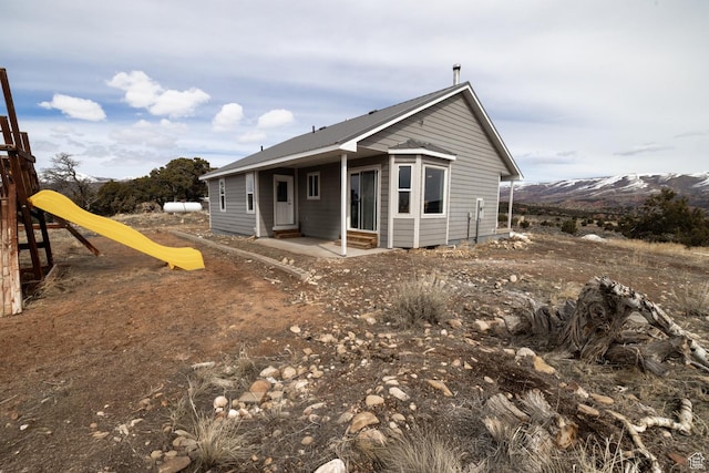 46501 W Bandanna Dr, Fruitland, UT 84027 - back of property featuring a mountain view, entry steps, and a playground
