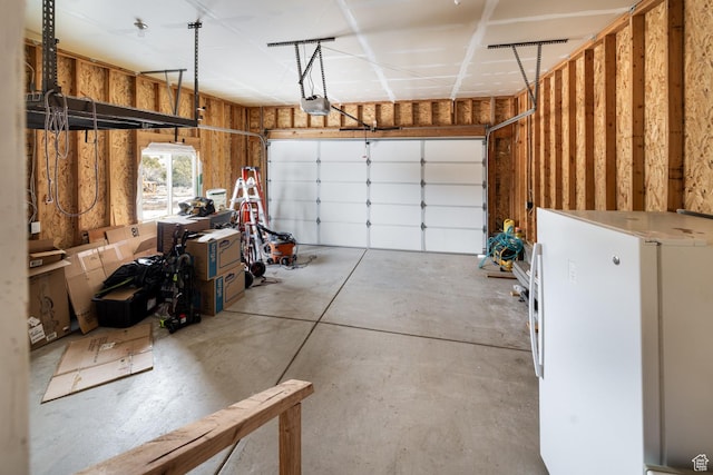 46501 W Bandanna Dr, Fruitland, UT 84027 - garage with a garage door opener and freestanding refrigerator